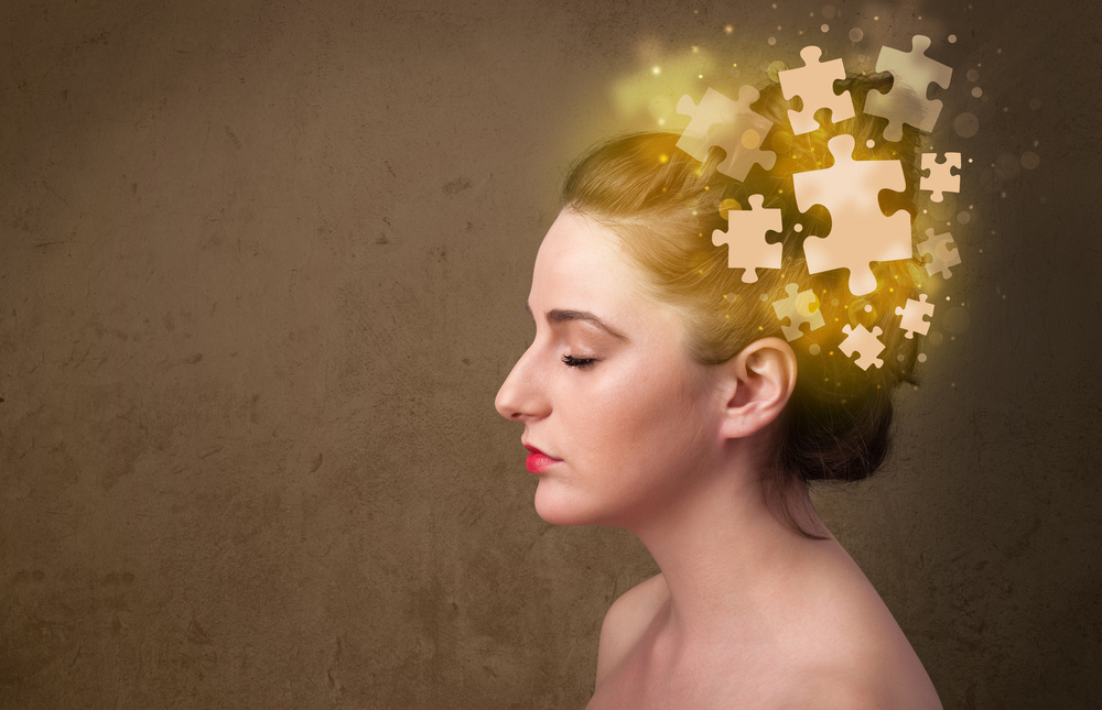 Young person thinking with glowing puzzle mind on grungy background